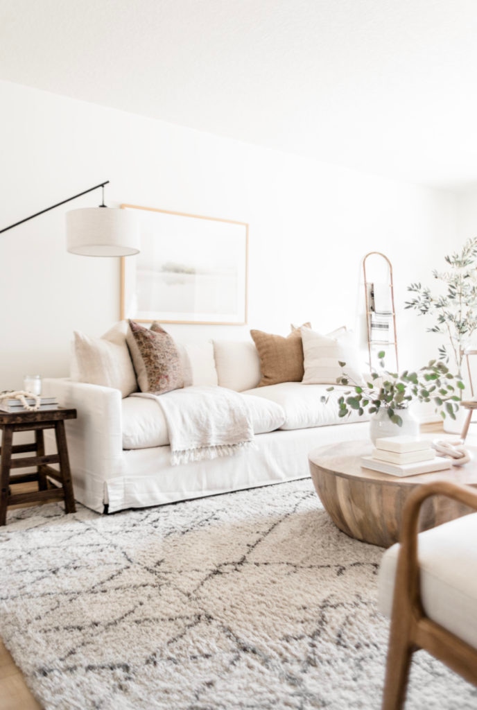 Living Room Update: World Market Sofa Reveal - Halfway Wholeistic; Click to see this living room update on Halfway Wholeistic! Our ivory sofa from World Market arrived & it's as pretty in person as online! The color is creamy white. The polyester-nylon upholstery is great! Living room decor ideas modern luxury. Living room ideas cozy warm rustic. Living room furniture arrangement ideas with fireplace and tv. Living room ideas modern contemporary luxury. Living room furniture sets couch. Couch pillow arrangement color combos. 