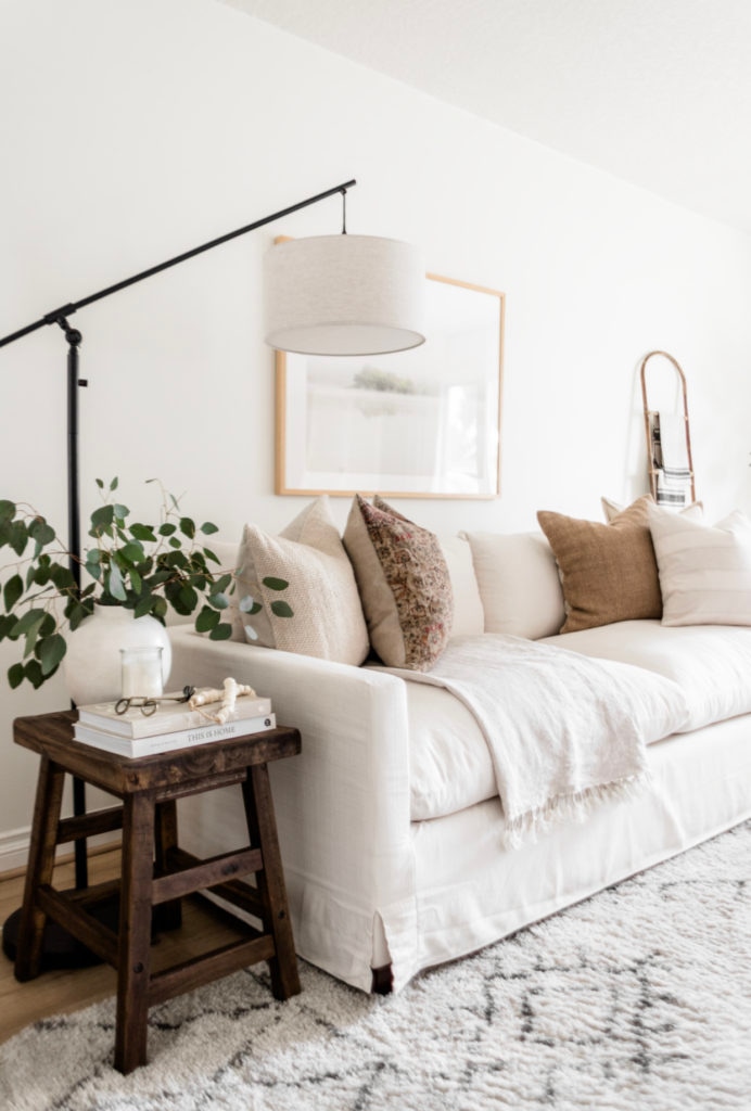 Living Room Update: World Market Sofa Reveal - Halfway Wholeistic; Click to see this living room update on Halfway Wholeistic! Our ivory sofa from World Market arrived & it's as pretty in person as online! The color is creamy white. The polyester-nylon upholstery is great! Living room decor ideas modern luxury. Living room ideas cozy warm rustic. Living room furniture arrangement ideas with fireplace and tv. Living room ideas modern contemporary luxury. Living room furniture sets couch. Couch pillow arrangement color combos. 