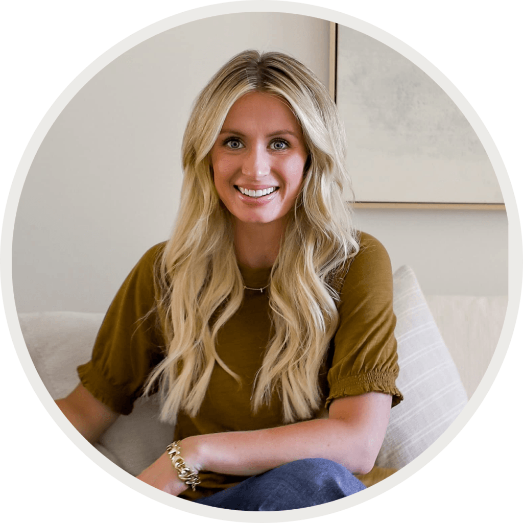 Photo of Katie sitting on the sofa smiling